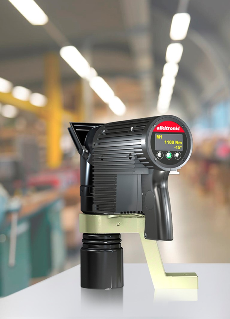 Alkitronic Electric Torque Multiplier product image with reaction bar - in black and on workshop table ready to use. 