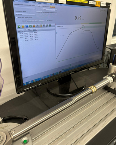 Side-by-side comparison of two torque wrenches being tested, with one showing inconsistent torque readings on a digital gauge and the other showing stable readings, demonstrating the difference in accuracy.