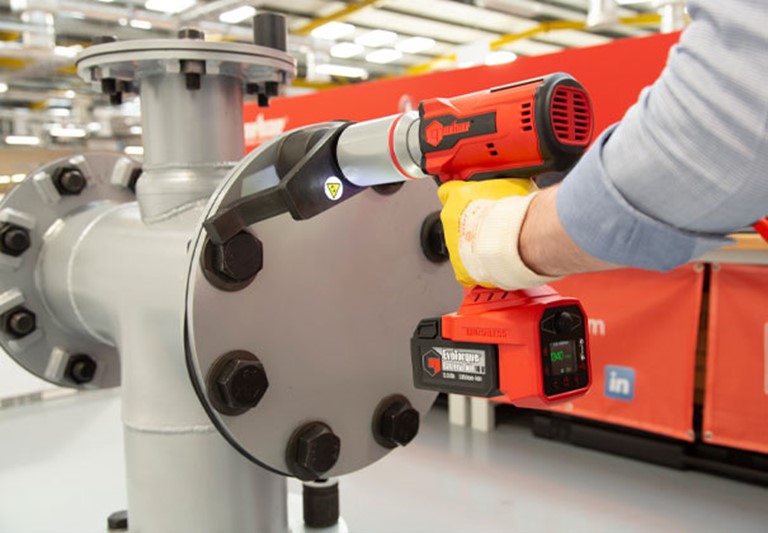 UKAS Torque Tool Calibration of Norbar Torque Multiplier impact driver hire demonstration . The tool is torquing up bolts on a steel flange With Ingersoll Rand in The Background.