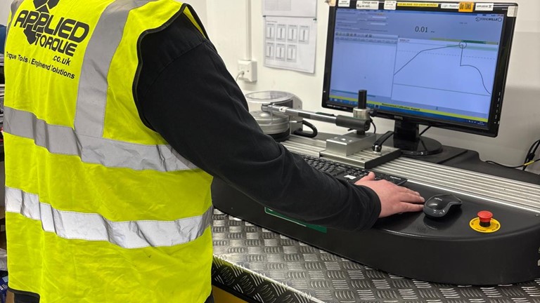 Torque Wrench Calibration Tool demonstration for an applied torque calibration technician. Torque wrench undergoing testing and issuing certification of compliance with UKAS & ISO standards.