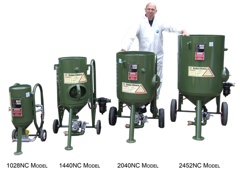 Hodge Clemco portable Blast machine product line up.  Including dry and wet portable shot and sand blasting machines in a green colour with a proud Hodge Clemco Employee looking over in a white PPE protective overall suit.