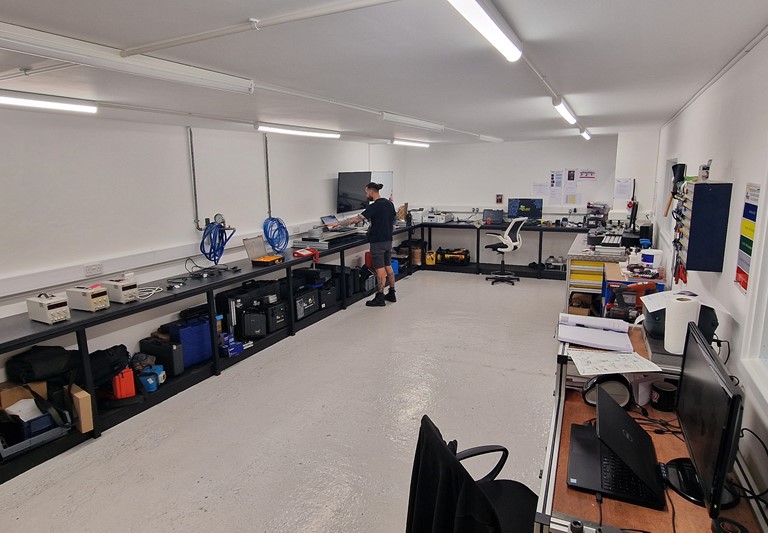 The Applied Torque Equipment Calibration Lab - Featuring Calibration tools and Applied Torque Employees Calibrating Equipment at their stations.