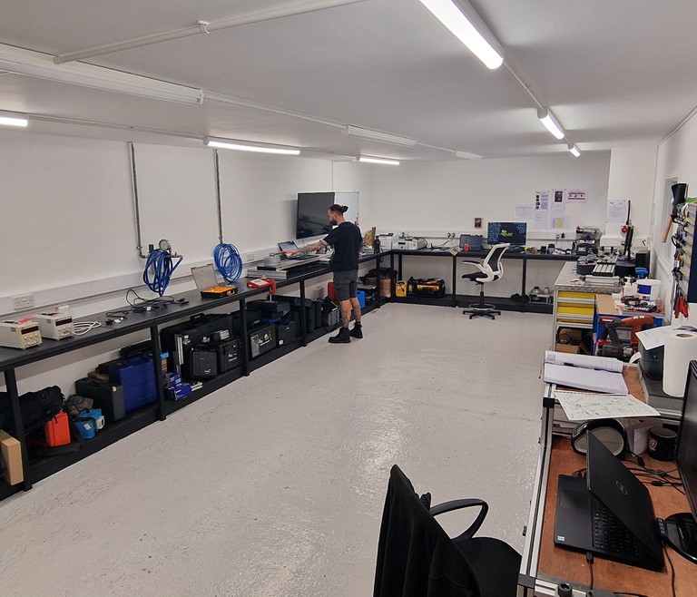 The Applied Torque Equipment Calibration Lab - Featuring Calibration tools and Applied Torque Employees Calibrating Equipment at their stations.